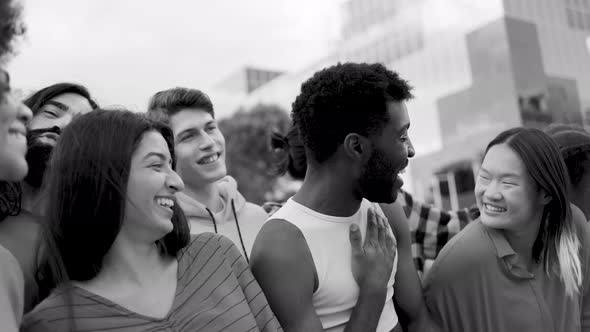 Diverse multiethnic friends having fun laughing outdoor - Diversity community - Black and white edit