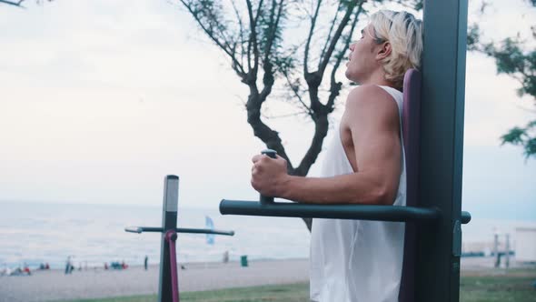 A Young Man Trains on an Outdoor Simulator By the Sea