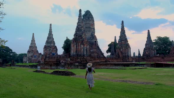 Women with Hat Tourist Visit Ayutthaya Thailand at Wat Chaiwatthanaram During Sunset