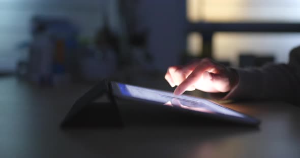 Typing on Tablet Computer at Night