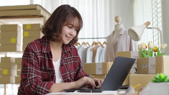 Asian small business entrepreneur ecommerce computer customer talk.