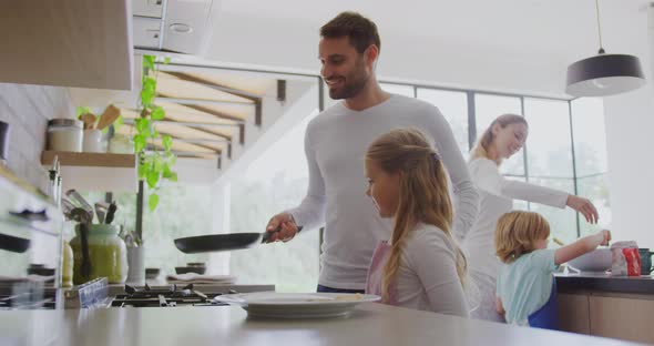 Family preparing food in kitchen at home 4k