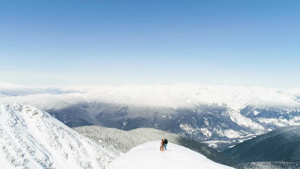 Skiers standing on a snow capped mountain