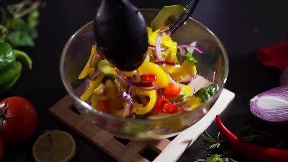 Closeup of Mixing Fresh Vegetable Salad