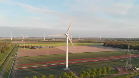 Picturesque View Of Wind Turbines In The Farm Fields Of Flevoland In Netherlands, Europe. Aerial Dro
