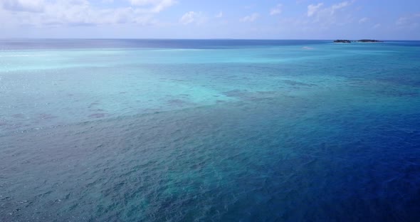 Natural birds eye travel shot of a white paradise beach and blue water background in best quality 4K