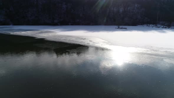 River in Winter with Sun Reflection 4K