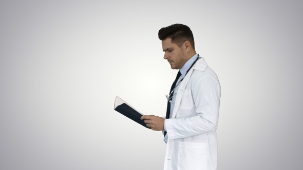 Concentrated medical doctor reading documentation while