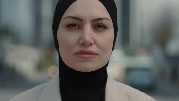 Portrait of Charming Arab Woman in Hijab Standing Outdoors