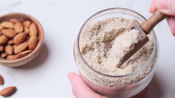 Almond flour in glass jar. Alternative nut flour.