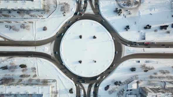 Roundabout Aerial Top View at Winter Day with Traffic of Cars and Trucks