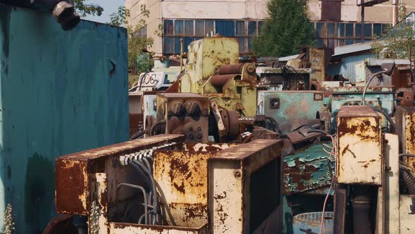 Old Abandoned Machines Stand in the Open Air Rusting From Natural Precipitation the Collapse of