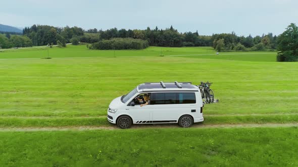 Small Camping Van with Bike Rack on Country Road