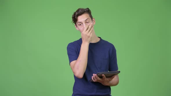 Young Handsome Teenage Boy Using Digital Tablet