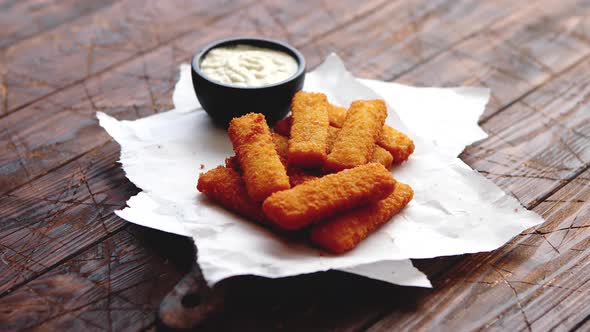 Pile of Golden Fried Fish Fingers with White Garlic Sauce