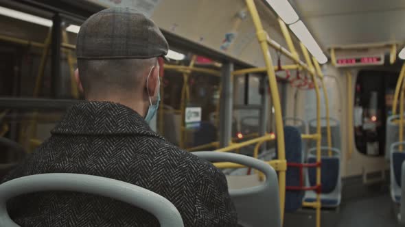 A European Guy in a Jacket Rides an Empty Bus