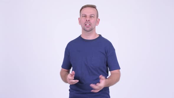 Portrait of Happy Blonde Man Presenting Something