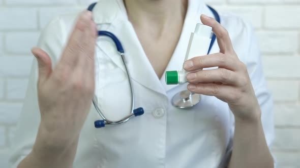 Doctor with inhaler for asthmatics