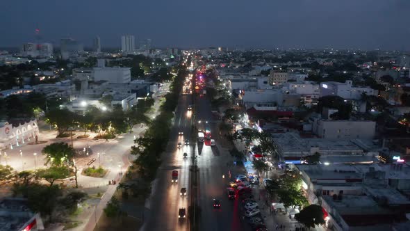 Forwards Fly Above Busy Street at Night