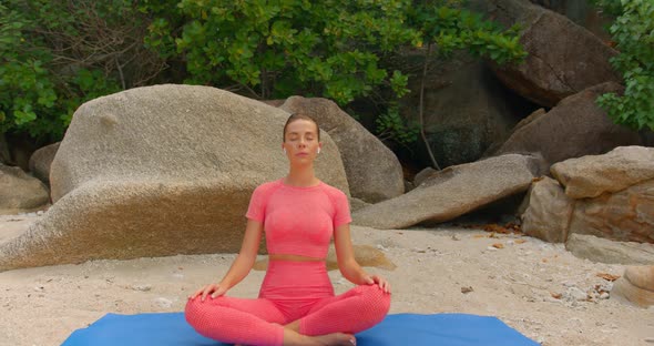 Close Up Shot of a Woman Practicing Yoga in the Morning She is Meditating on Yoga Mat