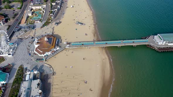 Aerial drone footage of the Bournemouth beach, Observation Wheel and Pier on a beautiful sunny day