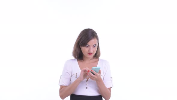 Happy Beautiful Businesswoman Using Phone and Looking Surprised