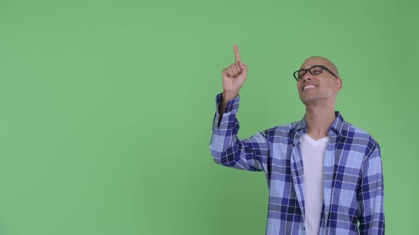 Happy Bald Hipster Man Pointing Up and Giving Thumbs Up