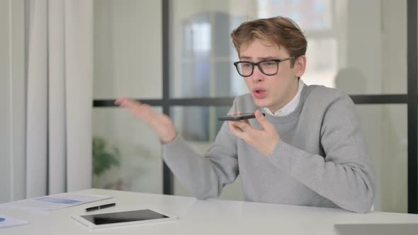 Angry Man Talking on Phone in Modern Office