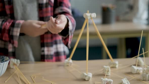 Schoolgirl setting up construction during a science lesson