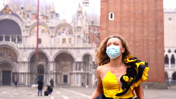 Woman in Mask and Festive Dress Walks Along St Mark Square
