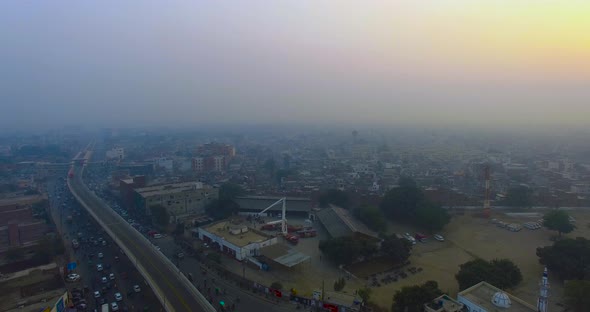 Aerial flight over the urban city, Bombay, India,Top view, crossing a metro bus bridge and a road, t