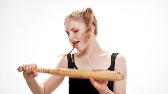 Young Beautiful Girl Smiling Dancing with Bat Over White Background