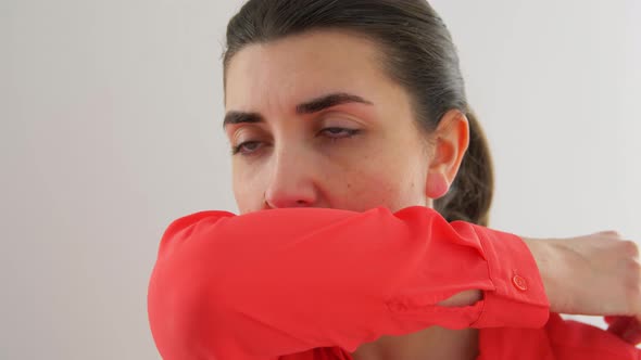 Woman Coughing Covering Mouth with Elbow