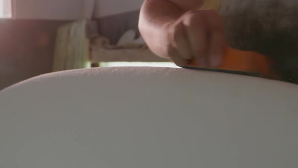 Male surfboard maker in his workshop