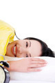 Happy young woman lying in bed and smiling to camera - PhotoDune Item for Sale