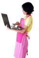 Young woman in pink appron using laptop - PhotoDune Item for Sale