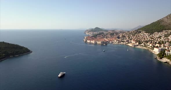 Dubrovnik Old Town from the sea with boats and clear skies.