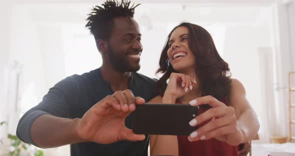 Happy couple taking a selfie indoors