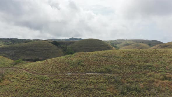 Drone Shot of White Clouds and Tropical Savannah Hills in Bali, Indonesia