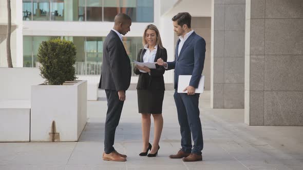 Multiethnic Business People Discussing Papers Outdoor