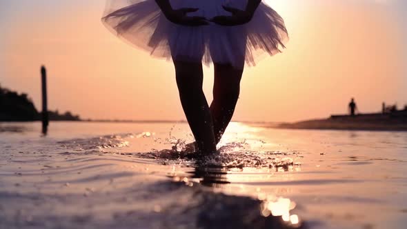 Silhouette of Woman Dancer Doing Ballet Exercises in Water