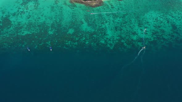 Turquoise clear water. Yachts, boats floating. Water Gradient from light to dark blue. Phi Phi don i