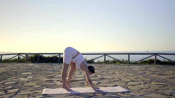 Slow motion shot of young woman doing yoga