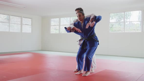 Judokas training by doing a randori on the judo mat