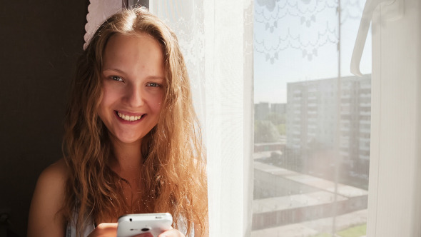 Young Woman Sends SMS Messages to Your Friends