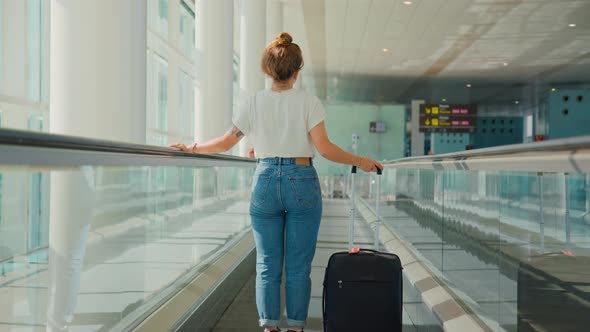 Young Millennial Traveler Woman in Empty Airport