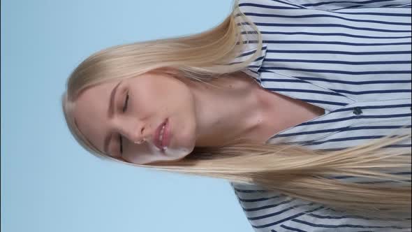 Upset Young Woman Beating Yourself on Forehead and Shooting Herself in the Head with Finger Gun