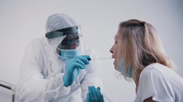 Doctor Performing Nasal Swab Covid Test on an Elderly Woman