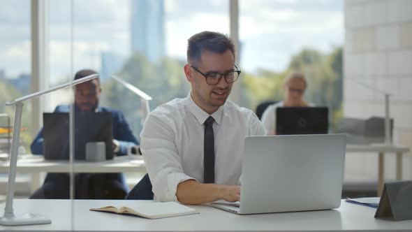 Young Businessman Concentrate on Working with Laptop Computer at Office