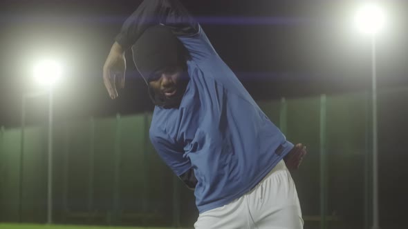 Man Stretching on Soccer Field